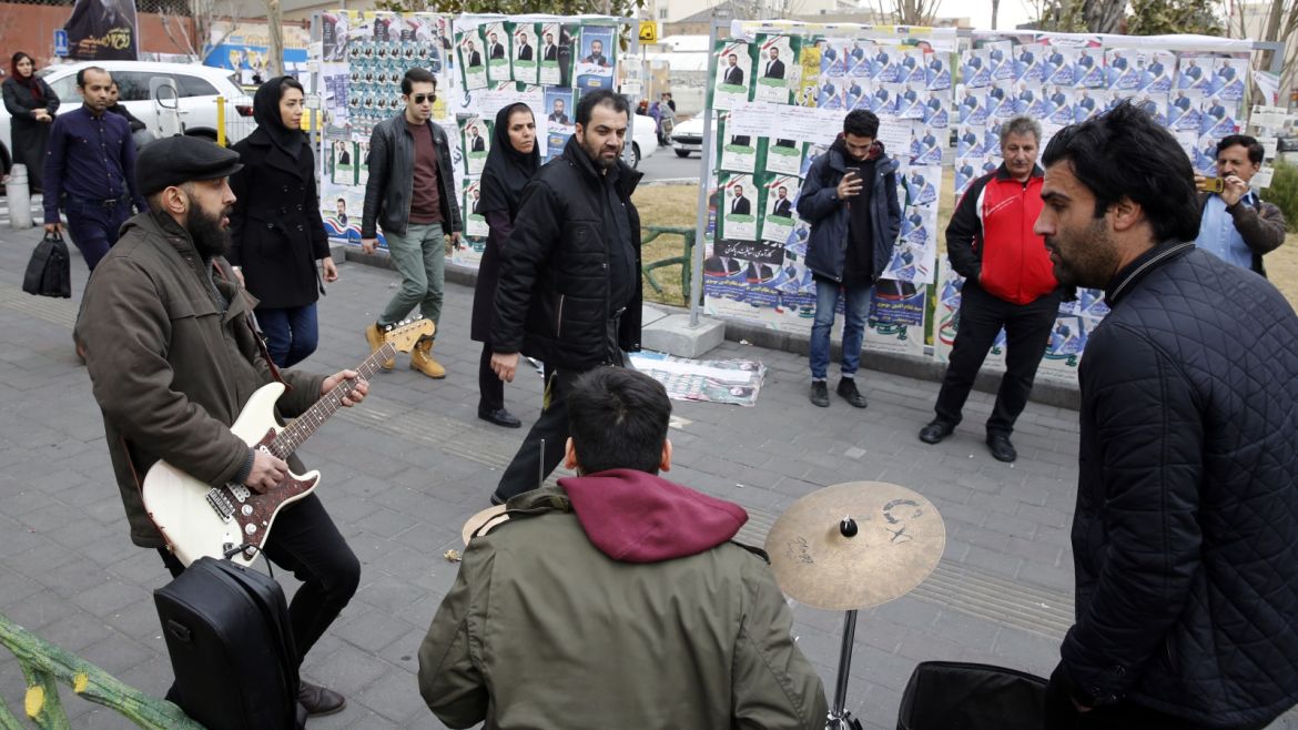 epa08227777 Iranian street musicians perform next to the electoral posters and fliers during the last day of election campaign, Tehran, Iran, 19 February 2020. Iranians will go to the polls to vote in the parliamentary elections on 21 February 2020.  EPA-EFE/ABEDIN TAHERKENAREH