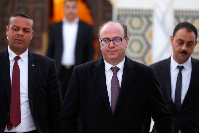 Tunisian Prime Minister Elyes Fakhfakh (C) leaves for a meeting with Tunisian President Kais Saied (not pictured) in Tunis, Tunisia February 15, 2020. REUTERS/Zoubeir Souissi