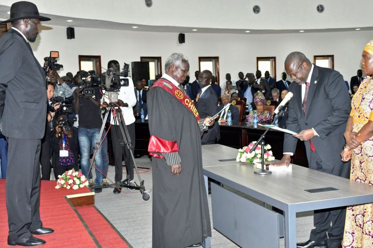 South Sudan's First Vice President Riek Machar stands with his wife Angelina Teny as he takes the oath of office in front of Sudan's President Salva Kiir and Chief of Justice Chan Reech Madut, at the State House in Juba, South Sudan, February 22, 2020. REUTERS/Jok Solomun