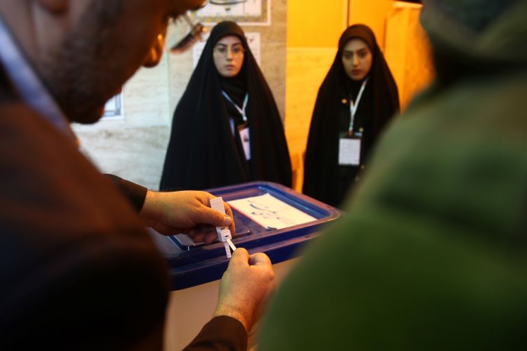 An Iranian man closes an empty ballot box before starting the vote at a polling station during parliamentary elections in Tehran, Iran February 21, 2020. Nazanin Tabatabaee/WANA (West Asia News Agency) via REUTERS ATTENTION EDITORS - THIS IMAGE HAS BEEN SUPPLIED BY A THIRD PARTY.