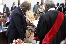 South Sudan's First Vice President Riek Machar stands with his wife Angelina Teny as he takes the oath of office in front of Chief of Justice Chan Reech Madut, at the State House in Juba, South Sudan, February 22, 2020. REUTERS/Samir Bol