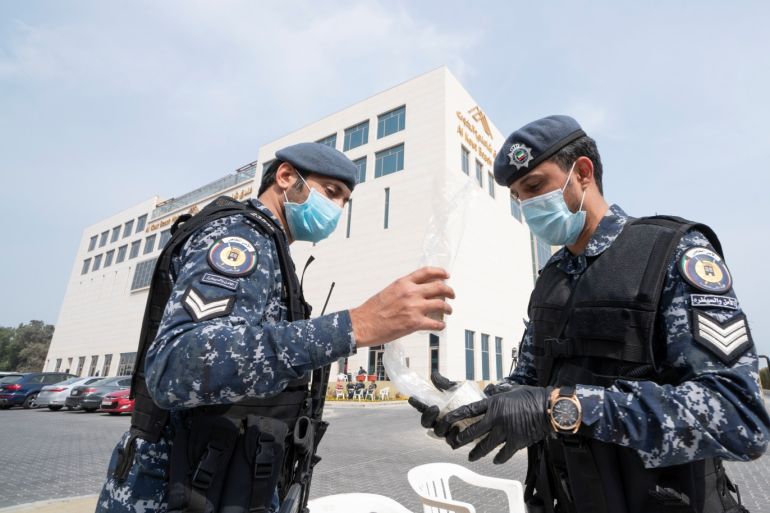 Kuwaiti special forces wearing protective masks are seen at the entrance to a hotel where people evacuated from Iran are being held in quarantine, in Fahaheel, Kuwait February 24,2020. REUTERS/Stephanie McGehee