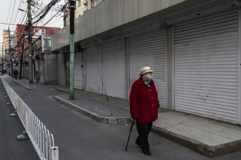 BEIJING, CHINA - FEBRUARY 25: A Chinese woman wears a protective mask as she walks by closed shops on February 25, 2020 in Beijing, China. The number of cases of the deadly new coronavirus COVID-19 being treated in China was more than 47,000 in mainland China Tuesday, in what the World Health Organization (WHO) has declared a global public health emergency. China continued to lock down the city of Wuhan in an effort to contain the spread of the pneumonia-like disease which medicals experts have confirmed can be passed from human to human. In an unprecedented move, Chinese authorities have maintained and in some cases tightened the travel restrictions on the city which is the epicentre of the virus and also in municipalities in other parts of the country affecting tens of millions of people. The number of those who have died from the virus in China climbed to over 2,666 on Monday mostly in Hubei province, and cases have been reported in other countries including the United States, Canada, Australia, Japan, South Korea, India, Iran, Italy, the United Kingdom, Germany, France and several others. The World Health Organization has warned all governments to be on alert and screening has been stepped up at airports around the world. Some countries, including the United States, have put restrictions on Chinese travellers entering and advised their citizens against travel to China. (Photo by Kevin Frayer/Getty Images)