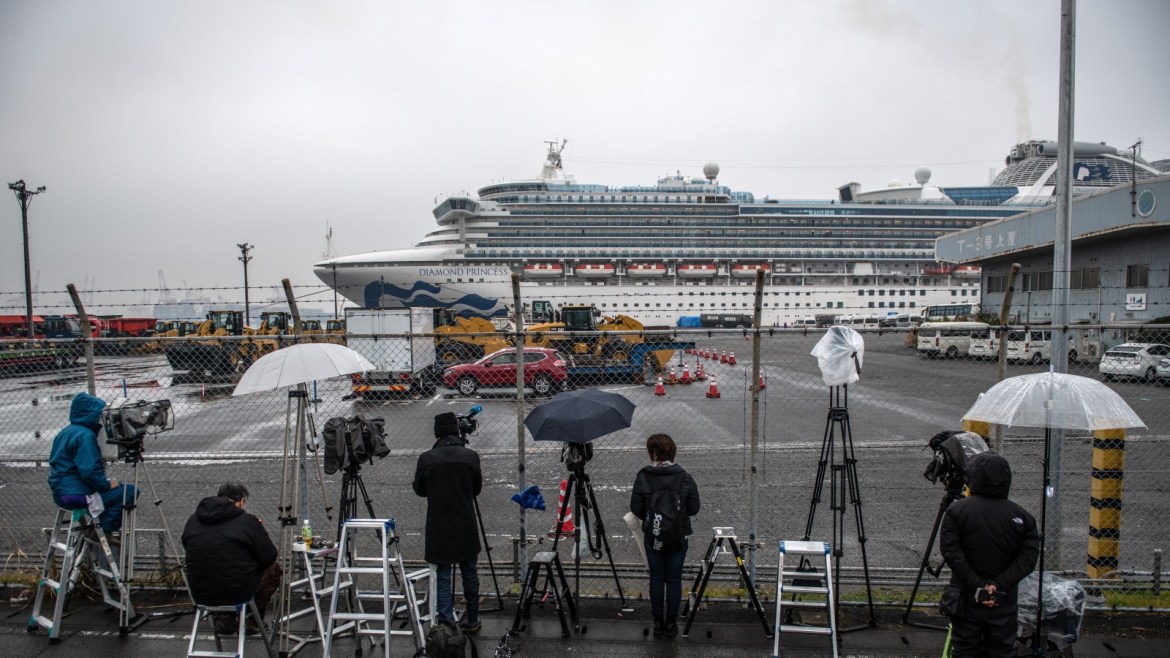 YOKOHAMA, JAPAN - FEBRUARY 16: Members of the media wait near the Diamond Princess cruise ship as U.S citizens prepare for repatriation while it remains in quarantine at Daikoku Pier on February 16, 2020 in Yokohama, Japan. The United States has become the first country to offer to repatriate citizens on the Diamond Princess cruise ship while it remains quarantined in Yokohama Port as at least 285 passengers and crew onboard have tested positive for the coronavirus (COV