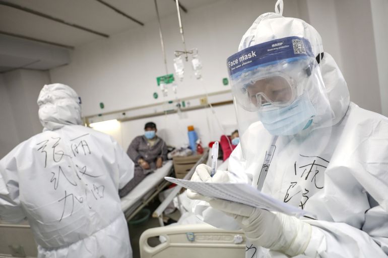 A medical worker in protective suit checks a patient's records at Jinyintan hospital in Wuhan, the epicentre of the novel coronavirus outbreak, in Hubei province, China February 13, 2020. Picture taken February 13, 2020. China Daily via REUTERS ATTENTION EDITORS - THIS IMAGE WAS PROVIDED BY A THIRD PARTY. CHINA OUT.