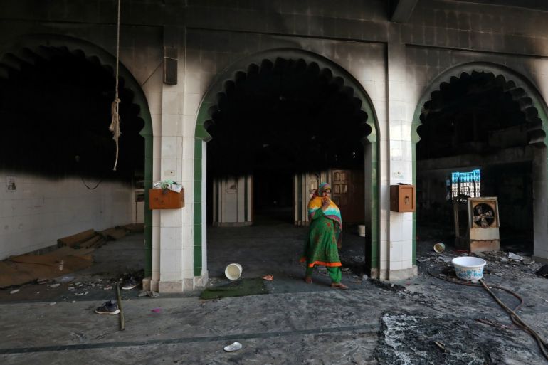 A woman walks inside a partially damaged mosque after it was set on fire by a mob in a riot affected area after clashes erupted between people demonstrating for and against a new citizenship law in New Delhi, India, February 26, 2020. REUTERS/Rupak De Chowdhuri