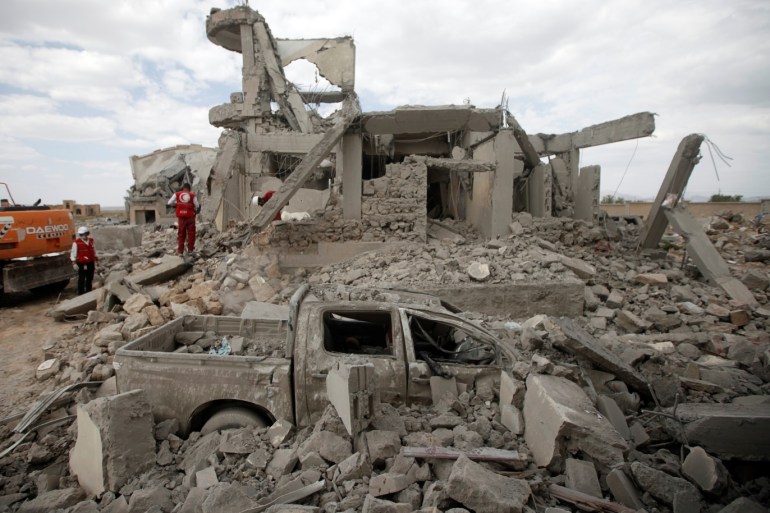 Destroyed car is seen between rubble as Red Crescent medics inspect the site of Saudi-led air strikes on a Houthi detention centre in Dhamar, Yemen, September 1, 2019. REUTERS/Mohamed al-Sayaghi