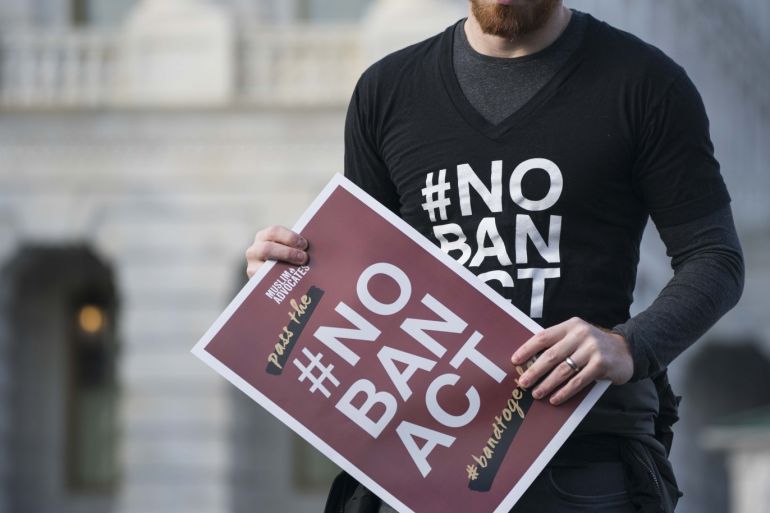 WASHINGTON, DC - JANUARY 27: A man holds a sign showing their support of ending a travel ban on Muslim majority countries at a news conference outside of the U.S. Capitol on January 27, 2020 in Washington, DC. Senate and House democrats are calling for the passage of the NO BAN Act to end President Trump's travel ban which they call discriminatory. Sarah Silbiger/Getty Images/AFP== FOR NEWSPAPERS, INTERNET, TELCOS & TELEVISION USE ONLY ==