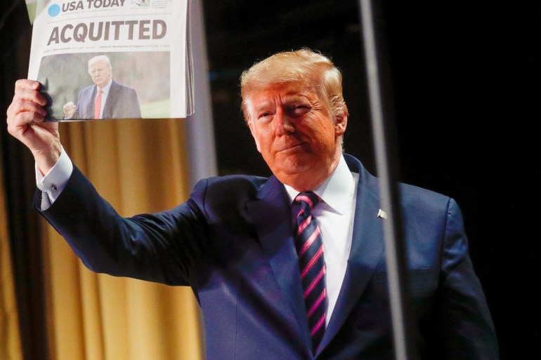 U.S. President Donald Trump holds up a copy of USA Today's front page showing news of his acquitttal in his Senate impeachment trial, as he arrives to address the National Prayer Breakfast in Washington, U.S., February 6, 2020. REUTERS/Leah Millis
