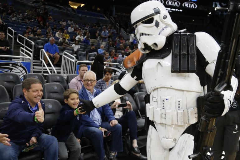 Jan 4, 2020; Orlando, Florida, USA; Fans get a high five from a Star Wars characters as part of Star Wars Night before the game between the Orlando Magic and the Utah Jazz at Amway Center. Mandatory Credit: Reinhold Matay-USA TODAY Sports
