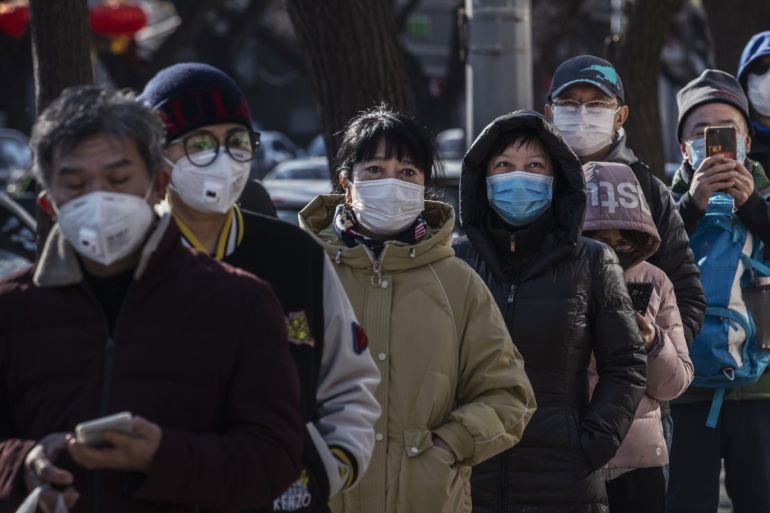 BEIJING, CHINA - FEBRUARY 16: Chinese customers wear protective masks as they line up single file to buy dumplings at a popular local shop on February 16, 2020 in Beijing, China. The number of cases of the deadly new coronavirus COVID-19 rose to more than 57000 in mainland China Sunday, in what the World Health Organization (WHO) has declared a global public health emergency. China continued to lock down the city of Wuhan in an effort to contain the spread of the pneumo
