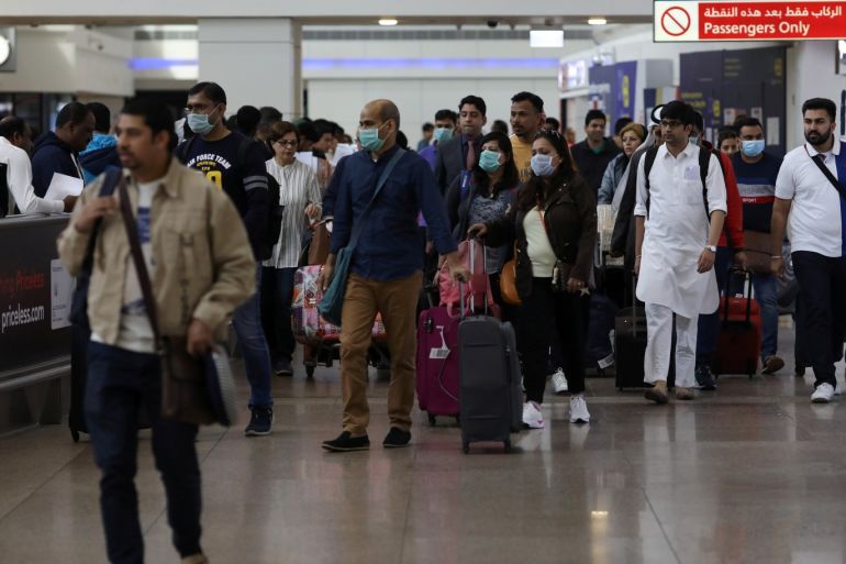 Travellers wear masks as they arrivw at the Dubai International Airport, after the UAE's Ministry of Health and Community Prevention confirmed the country's first case of coronavirus, in Dubai, United Arab Emirates January 29, 2020. REUTERS/Christopher Pike