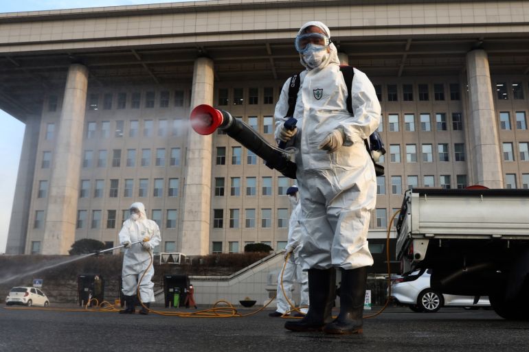 SEOUL, SOUTH KOREA - FEBRUARY 24: Disinfection professionals wear protective gear spray anti-septic solution against the coronavirus (COVID-19) at a National Assembly on February 24, 2020 in Seoul, South Korea. The National Assembly called off its plenary session and temporarily closed its buildings after it was learned that a coronavirus patient attended a parliamentary forum last week. Government has raised the coronavirus alert to the
