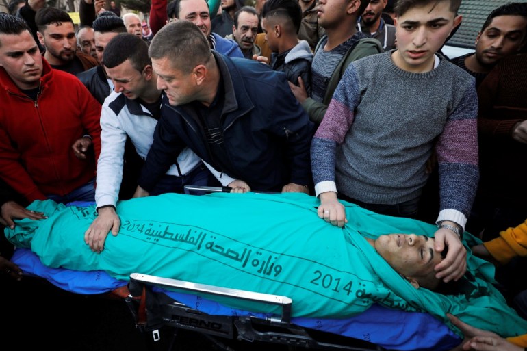 SENSITIVE MATERIAL. THIS IMAGE MAY OFFEND OR DISTURB People gather around the body of 17-year-old Palestinian Mohammed Al-Hadad at a hospital in Hebron in the Israeli-occupied West Bank February 5, 2020. REUTERS/Mussa Qawasma