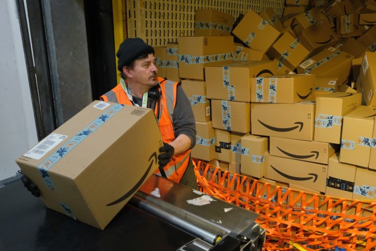 BRIESELANG, GERMANY - NOVEMBER 28: A worker loads a truck with packages at an Amazon packaging center on November 28, 2019 in Brieselang, Germany. Amazon is anticipating a strong holiday season and has hired extra workers at its packaging center across Germany. Meanwhile workers at some of the centers, though not at Brieselang, have announced strikes to further their demands for better pay. (Photo by Sean Gallup/Getty Images)