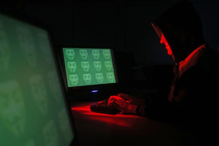 Man poses in front of on a display showing the word 'cyber' in binary code, in this picture illustration taken in Zenica December 27, 2014. A previously undisclosed hacking campaign against military targets in Israel and Europe is probably backed by a country that misused security-testing software to cover its tracks and enhance its capability, researchers said. Picture taken December 27, 2014. REUTERS/Dado Ruvic (BOSNIA AND HERZEGOVINA - Tags: SCIENCE TECHNOLOGY CRIME LAW TPX IMAGES OF THE DAY)
