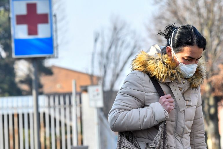 A woman wearing a face mask leaves the hospital of Codogno amid a coronavirus outbreak in northern Italy, in Codogno, Italy, February 22, 2020. REUTERS/Flavio Lo Scalzo