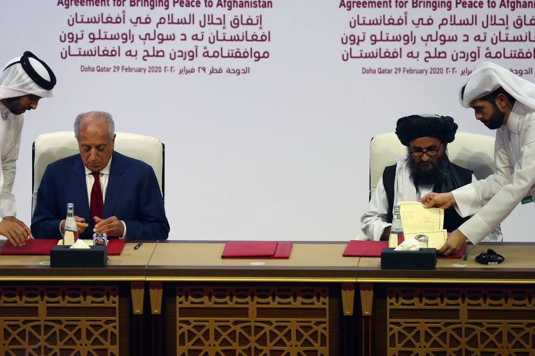Mullah Abdul Ghani Baradar, the leader of the Taliban delegation, signs an agreement with Zalmay Khalilzad, U.S. envoy for peace in Afghanistan, at a signing agreement ceremony between members of Afghanistan's Taliban and the U.S. in Doha, Qatar February 29, 2020. REUTERS/Ibraheem al Omari