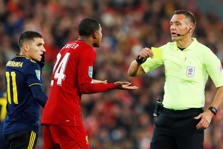 Soccer Football - Carabao Cup - Fourth Round - Liverpool v Arsenal - Anfield, Liverpool, Britain - October 30, 2019 Liverpool's Rhian Brewster is shown a yellow card by referee Andre Marriner Action Images via Reuters/Jason Cairnduff EDITORIAL USE ONLY. No use with unauthorized audio, video, data, fixture lists, club/league logos or