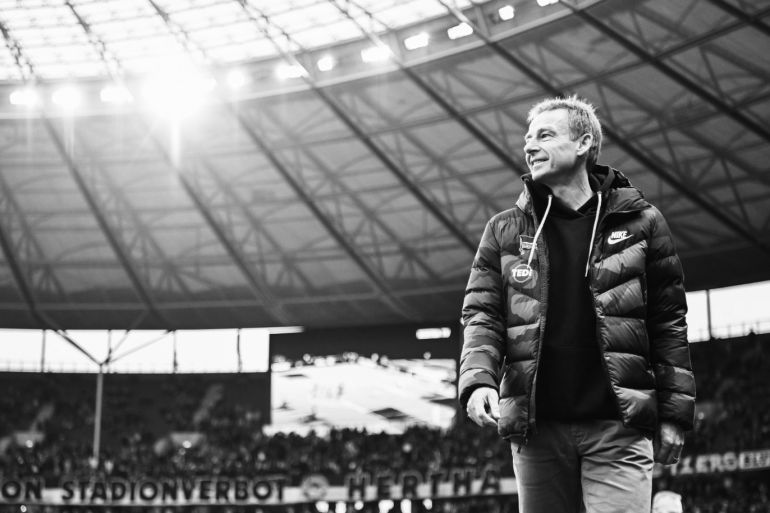 BERLIN, GERMANY - JANUARY 19: EDITORS NOTE: This images was converted into black and white from a color original). Jürgen Klinsmann, head coach of Berlin looks on during the Bundesliga match between Hertha BSC and FC Bayern Muenchen at Olympiastadion on January 19, 2020 in Berlin, Germany. (Photo by Stuart Franklin/Bongarts/Getty Images)