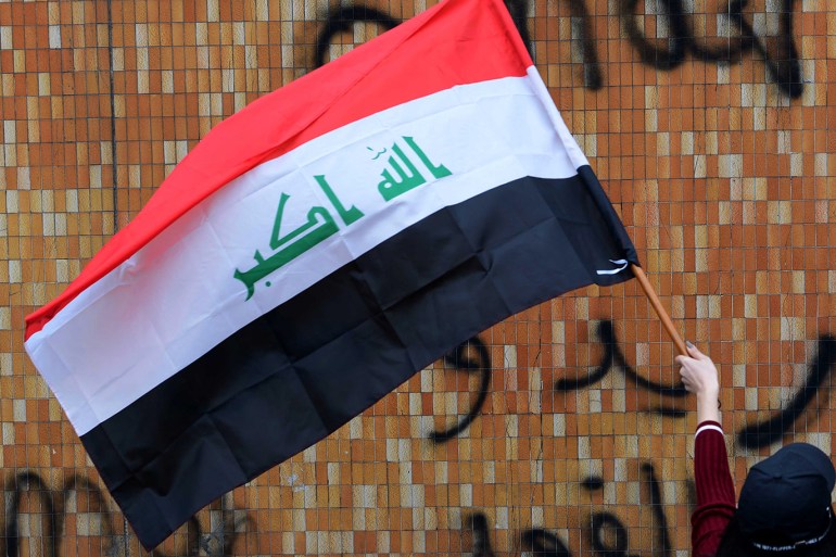 epa08206758 A female university student carries the Iraqi national flag during a strike and protests in central Baghdad, Iraq, 09 February 2020. Thousands of Iraqi students continue their protests in Baghdad and southern Iraqi cities against the appointment of Mohammed Tawfiq Allawi as prime minister-designate. EPA-EFE/MURTAJA LATEEF