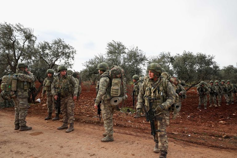 Turkish soldiers gather in the village of Qaminas, about 6 kilometers southeast of Idlib city in northwestern Syria, Feb. 10, 2020.