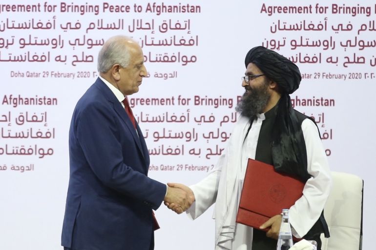 Taliban and US sign landmark peace deal in Doha, Qatar- - QATAR, DOHA - FEBRUARY 29: US Special Representative for Afghanistan Reconciliation Zalmay Khalilzad (L) and Taliban co-founder Mullah Abdul Ghani Baradar (R) shake hands after signing the peace agreement between US, Taliban, in Doha, Qatar on February 29, 2020.