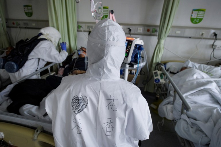 Medical workers in protective suits attend to novel coronavirus patients inside an isolated ward at a hospital in Wuhan, Hubei province, China February 6, 2020. Picture taken February 6, 2020. China Daily via REUTERS ATTENTION EDITORS - THIS IMAGE WAS PROVIDED BY A THIRD PARTY. CHINA OUT.