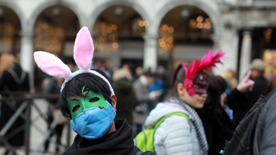 A carnival reveller wears a protective mask at Venice Carnival, which the last two days of, as well as Sunday night's festivities, have been cancelled because of an outbreak of coronavirus, in Venice, Italy February 23, 2020. REUTERS/Ohad Zwigenberg ISRAEL OUT. NO COMMERCIAL OR EDITORIAL SALES IN ISRAEL