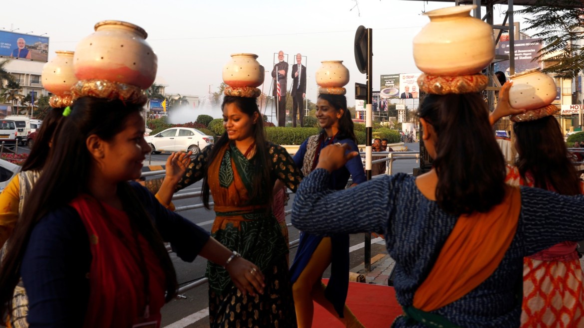 Girls perform a folk dance in front of cutouts of India's Prime Minister Narendra Modi and U.S. President Donald Trump along a road, during a rehearsal ahead of Trump's visit, in Ahmedabad, India, February 23, 2020. REUTERS/Adnan Abidi