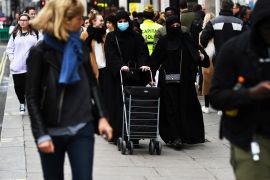 Muslim women wear faces masks as they walk, as the number of coronavirus cases grow around the world, in central London, Britain March 14, 2020. REUTERS/Dylan Martinez