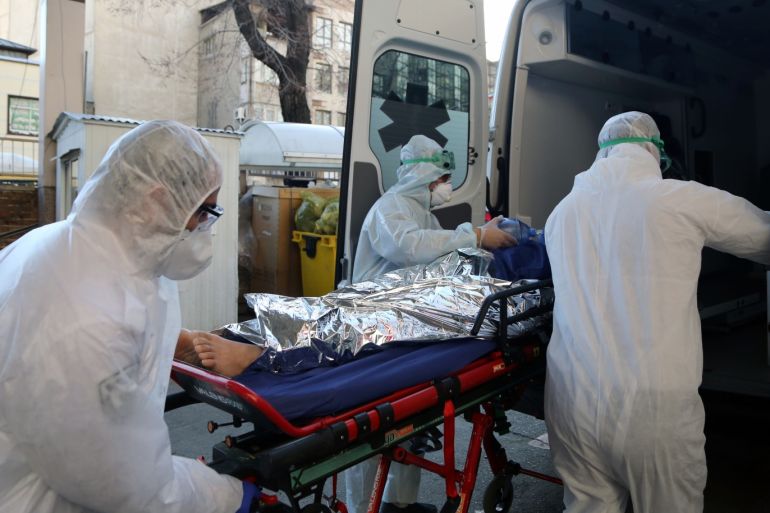 Coronavirus: Death toll in Iran climbs to 66- - TEHRAN, IRAN - MARCH 02: Ambulance staff wearing protective masks and suits take a patient to a hospital as death toll from coronavirus (Covid-19) rises to 66 in Tehran, Iran on March 02, 2020. The death toll from coronavirus in Iran has reached to 66 as 12 more people lost their lives due to the virus and the total number of confirmed cases rose to 1,501.