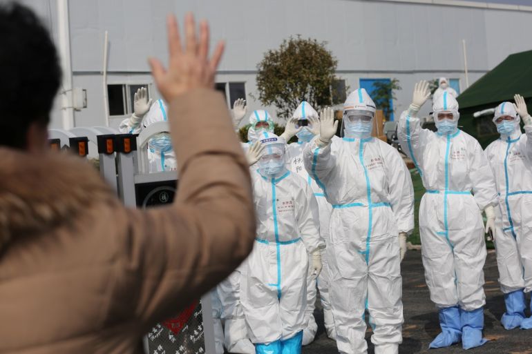 Medical personnel in protective suits wave hands to a patient who is discharged from the Leishenshan Hospital after recovering from the novel coronavirus, in Wuhan, the epicentre of the novel coronavirus outbreak, in Hubei province, China March 1, 2020. Picture taken March 1, 2020. China Daily via REUTERS ATTENTION EDITORS - THIS IMAGE WAS PROVIDED BY A THIRD PARTY. CHINA OUT.