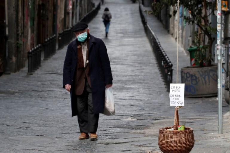 A basket hung up so people can donate or take for free food is seen, as Italy struggles to contain the spread of coronavirus disease (COVID-19), in Naples, Italy March 30, 2020. The sign reads: