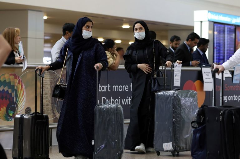 Travellers wear masks as they arrive at the Dubai International Airport, after the UAE's Ministry of Health and Community Prevention confirmed the country's first case of coronavirus, in Dubai, United Arab Emirates January 29, 2020. REUTERS/Christopher Pike