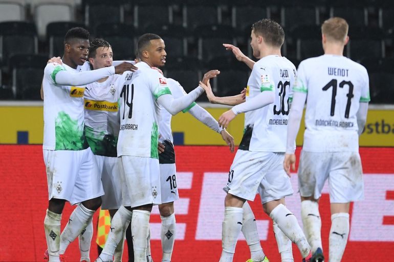 MOENCHENGLADBACH, GERMANY - MARCH 11: Breel Embolo of Borussia Monchengladbach celebrates his sides second goal with Alassane Plea, Stefan Lainer, Raffael and other team mates after a 1. FC Koeln own goal during the Bundesliga match between Borussia Moenchengladbach and 1. FC Koeln at Borussia-Park on March 11, 2020 in Moenchengladbach, Germany. For the first time in the history of the German Bundesliga the match is played behind closed doors as a precaution against the spread of COVID-19 (Coronavirus). (Photo by Jörg Schüler/Bongarts/Getty Images)