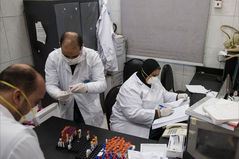 epa08298766 Doctors works at the samples collecting room at the Central Public Health Laboratories in Cairo, Egypt, 16 March 2020. The number of cases infected with SARS-CoV-2 Coronavirus causing the Covid-19 disease in Egypt increased to 126. EPA-EFE/MOHAMED HOSSAM