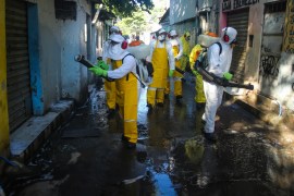 NITEROI, BRAZIL - MARCH 25: Agents of the sanitary department clean streets and alleys of the Vila Ipiranga Favela, in Fonseca neighborhood on March 25, 2020 in Niteroi, Brazil. Vila Ipiranga is the first community (Favela) in the country to receive the visit of sanitary agents using the same technology applied in China to help prevent the spreading of the coronavirus (COVID-19). According to the Ministry of health, as of today, Brazil has 2271 confirmed cases infected