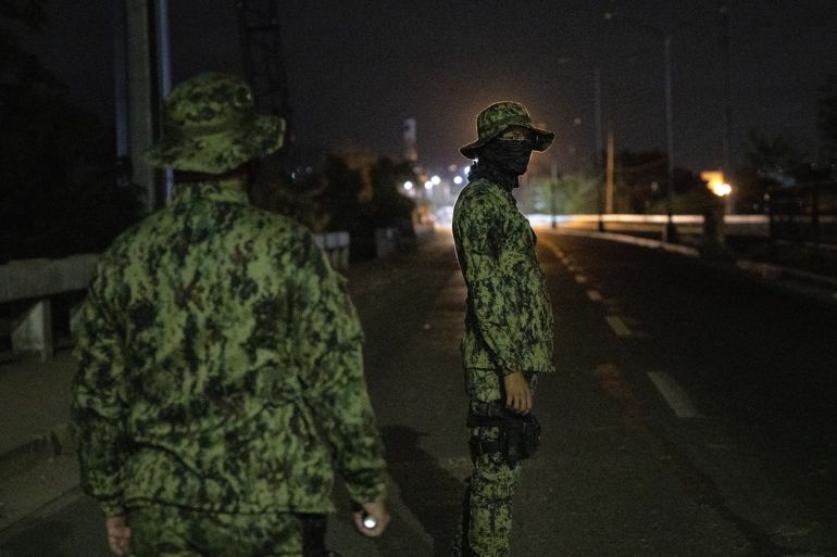 QUEZON, PHILIPPINES - MARCH 15: Filipino troops stand guard at a checkpoint as authorities begin implementing a lockdown on Manila on March 15, 2020 in the outskirts of Metro Manila, Philippines. The Philippine government is placing some 12 million people in the capital Manila on lockdown as well as suspending government work for a month to prevent the spread of COVID-19. As of Saturday evening, the Philippines' Department of Health has confirmed 111 cases of the deadly coronavirus in the country, with at least 8 recorded fatalities. (Photo by Ezra Acayan/Getty Images)