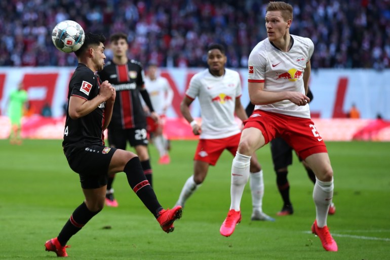 LEIPZIG, GERMANY - MARCH 01: Nadiem Amiri of Bayer 04 Leverkusen battles for possession with Marcel Halstenberg of RB Leipzig during the Bundesliga match between RB Leipzig and Bayer 04 Leverkusen at Red Bull Arena on March 01, 2020 in Leipzig, Germany. (Photo by Alex Grimm/Bongarts/Getty Images)