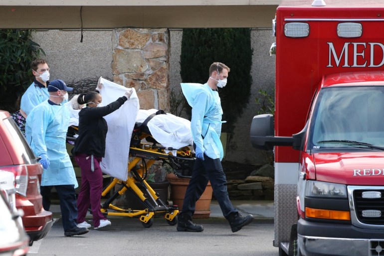 KIRKLAND, WA - MARCH 07: A patient is transferred into an ambulance at the Life Care Center on March 7, 2020 in Kirkland, Washington. As of today, 11 residents have died from COVID-19, since February 19th. Currently, there are 63 residents in the facility, slightly more than half of the 120 residents that were here before the first case was reported. Karen Ducey/Getty Images/AFP== FOR NEWSPAPERS, INTERNET, TELCOS & TELEVISION USE ONLY ==