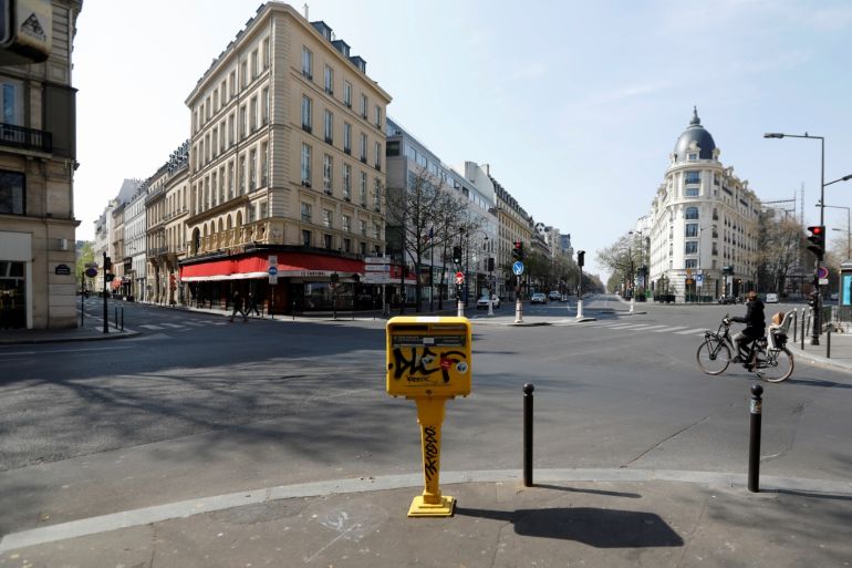 A cyclist rides on the deserted Grands Boulevards in Paris as a lockdown is imposed to slow the rate of the coronavirus disease (COVID-19) in France, March 27, 2020. REUTERS/Charles Platiau