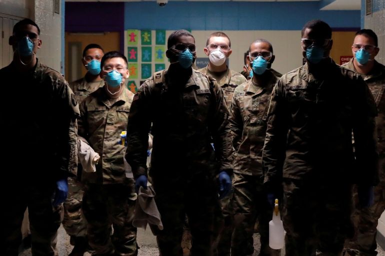 Members of Joint Task Force 2, composed of soldiers and airmen from the New York Army and Air National Guard, work to sanitize the New Rochelle High School during the coronavirus disease (COVID-19) outbreak in New Rochelle, New York, U.S., March 21, 2020. REUTERS/Andrew Kelly TPX IMAGES OF THE DAY