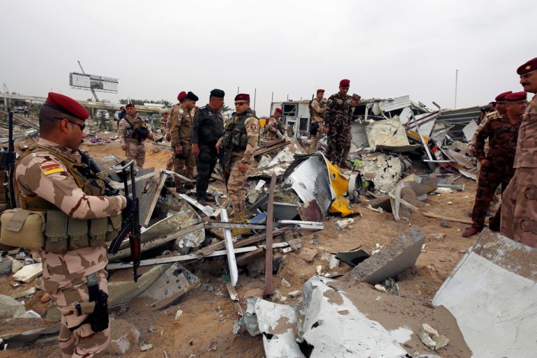 Members of Iraqi security forces check the damages a civilian airport under construction which, according to Iraqi religious authorities, was hit by a U.S. air strike, in the holy Shi'ite city of Kerbala, Iraq March 13, 2020. REUTERS/Alaa al-Marjani