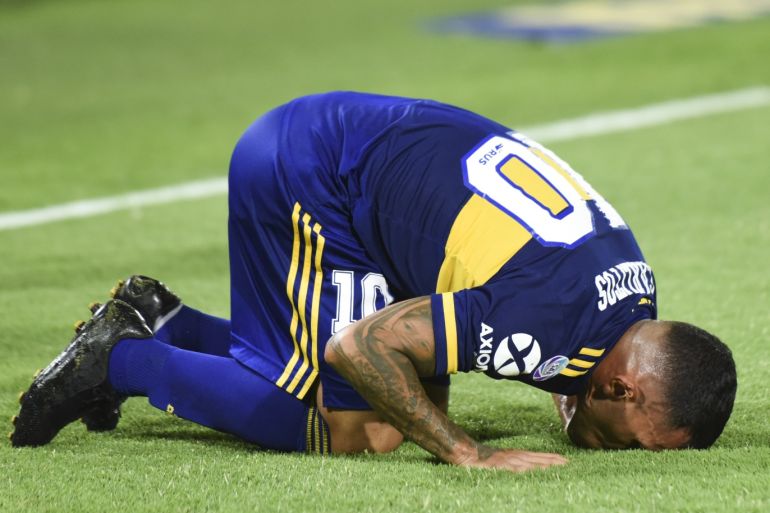 BUENOS AIRES, ARGENTINA - MARCH 07: Carlos Tevez of Boca Juniors celebrates after scoring the first goal of his team as he kisses the pitch during a match between Boca Juniors and Gimnasia as part of Superliga 2019/20 at Estadio Alberto J. Armando on March 7, 2020 in Buenos Aires, Argentina. (Photo by Rodrigo Valle/Getty Images)