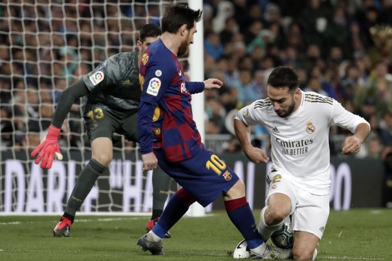 Real Madrid vs Barcelona - La Liga- - MADRID, SPAIN - MARCH 1: Dani Carvajal of Real Madrid in action against Lionel Messi of Barcelona during the Spanish League football match between Real Madrid and Barcelona at the Santiago Bernabeu stadium in Madrid on March 1, 2020.