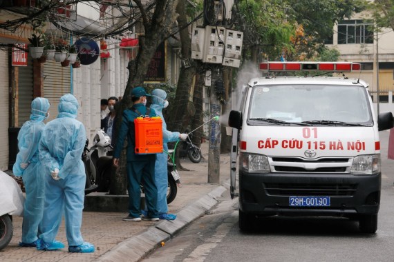 A health worker disinfects an ambulance near the house of a corona virus infected patient at a quarantined street in Hanoi, Vietnam March 7, 2020. REUTERS/Kham