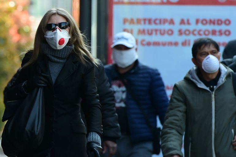 Coronavirus outbreak in Italy- - MILAN, ITALY - MARCH 18: Some people walk wearing protective masks during the coronavirus outbreak on March 18, 2020 in Milan, Italy. Italian Government continues to enforce the nationwide lockdown as measures to control the coronavirus spread.