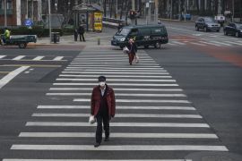 BEIJING, CHINA - MARCH 06: A Chinese man wears a protective mask as he crosses a street during the afternoon rush hour on March 6, 2020 in Beijing, China. The number of cases of the deadly new coronavirus COVID-19 being treated in China dropped to below 26,000 in mainland China Friday, in what the World Health Organization (WHO) declared a global public health emergency last month. China continued to lock down the city of Wuhan, the epicentre of the virus, in an effort to contain the spread of the pneumonia-like disease. Officials in Beijing have put in place a mandatory 14 day quarantine for all people returning to the capital from other places in China and countries with a large number of cases like South Korea and Japan. The number of those who have died from the virus in China climbed to over 3016 on Friday, mostly in Hubei province, and cases have been reported in other countries including the United States, Canada, Australia, Japan, South Korea, India, Iran, Italy, the United Kingdom, Germany, France and several others. The World Health Organization has warned all governments to be on alert and raised concerns over a possible pandemic. Some countries, including the United States, have put restrictions on Chinese travellers entering and advised their citizens against travel to China.(Photo by Kevin Frayer/Getty Images)