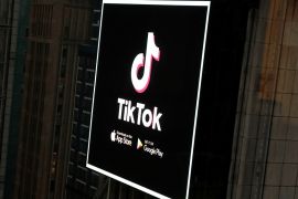 The TikTok logo is seen on a screen over Times Square in New York City, U.S., March 6, 2020. REUTERS/Andrew Kelly